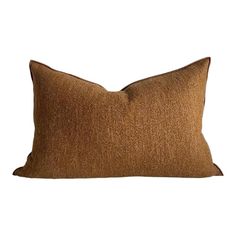 a brown pillow sitting on top of a white wall