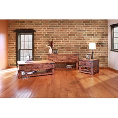 a living room filled with furniture and a brick wall