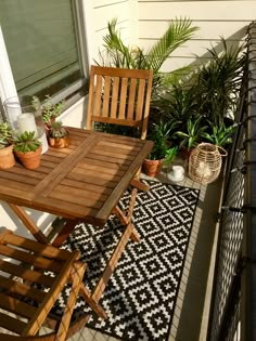 an image of a small balcony with plants on the table and two people sitting at the table