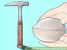 a hammer and rock being held by someone's hand with an object in the foreground