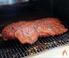 a piece of meat is cooking on the grill