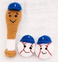 two crocheted baseball mitts with faces on them