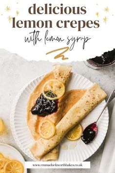 two lemon crepes on a white plate with blueberries and oranges next to it