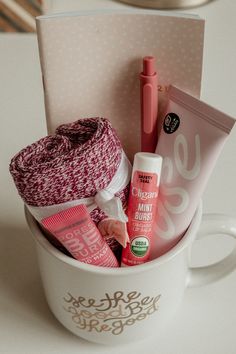 a cup filled with lots of items on top of a table