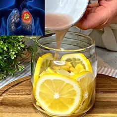 a person pouring liquid into a glass jar filled with lemons and other foodstuffs