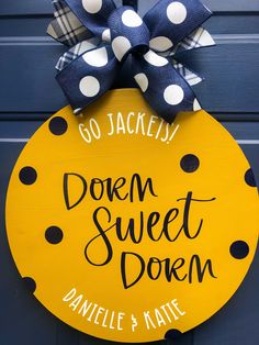 a yellow and black polka dot door hanger with the words down sweet dorm written on it