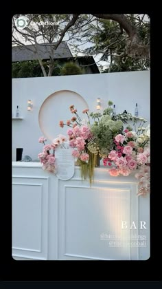 flowers are sitting on the counter in front of a white wall