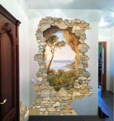 a stone wall with a painting on it in the middle of a hallway next to a doorway