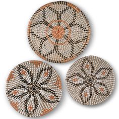 three woven plates with designs on them