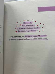 an open book with pink and purple writing on the pages that read for the lonely, the daydreames, the ones who find their friends between the pages of books