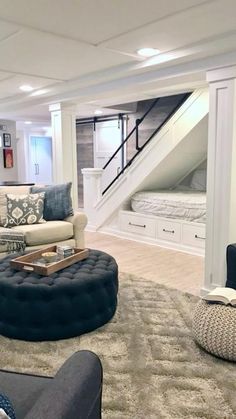 a living room filled with lots of furniture and pillows on top of carpeted flooring