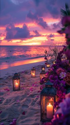 candles are lit on the beach as the sun sets