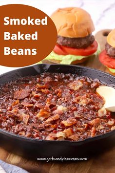 an iron skillet filled with baked beans and hamburgers in the background text reads smoked baked beans