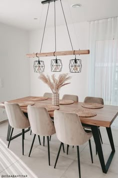 a dining room table and chairs in front of a window