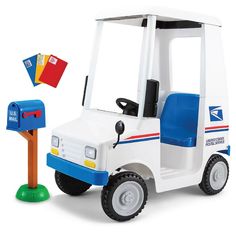 a white and blue toy truck next to a mailbox with a red, white, and blue flag on it