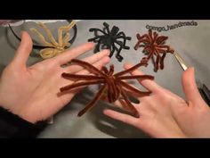 someone is making spider decorations out of paper