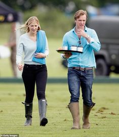 a man and woman walking in the grass