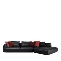 a black leather couch with red pillows on the top and bottom corner, against a white background