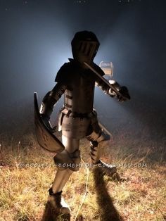 a robot standing in the middle of a field at night