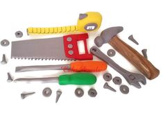 various tools are laid out on a white surface, including a saw, pliers and screwdrivers