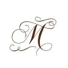 the letter m is made up of swirls and scrolls