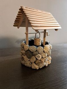 a bird house made out of rocks and wood