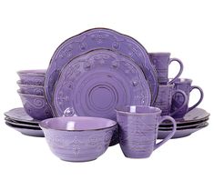 purple dishes and cups are stacked on top of each other