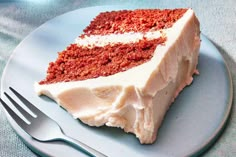 a piece of red velvet cake on a plate with a knife and fork next to it