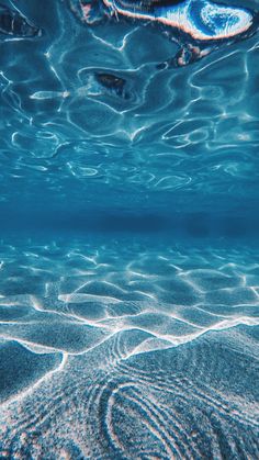 an underwater view of the water and sand