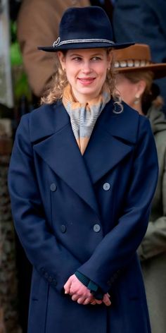 a woman wearing a blue coat and hat