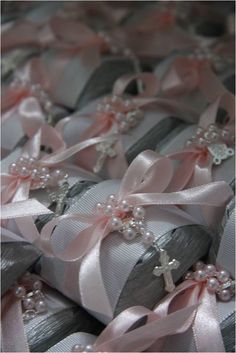 many wrapped presents with bows and pearls on them