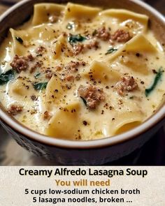 a bowl of creamy alfredo lasagna soup with sausage and spinach in it