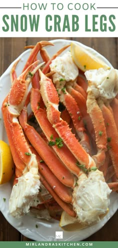 a white plate topped with crab legs covered in butter and garnished with lemon wedges