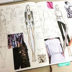 an open book with drawings and sketches of dresses on it's pages, including a pencil