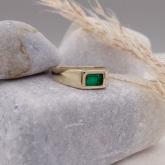 This 14k Natural Emerald Baguette Signet Ring is an exquisite piece of May birthstone jewelry. Crafted with precision, this ring showcases a vibrant green natural emerald stone, symbolizing youth and rejuvenation. Designed to suit both men and women, it serves as a versatile accessory, perfect for any occasion. The chunky yet elegant design adds a touch of sophistication, while the pinky ring style adds a trendy element. Whether it's an anniversary celebration or a special gift, this ring makes a truly timeless and meaningful statement. Elevate your jewelry collection with this mesmerizing emerald signet ring. Measurements: * Gem Stones: 100% Natural Emerald * Center Stone Measurements: 6.00x4.00 Approx. 0.50 * Color and Clarity: Clear Green * Material: High-Quality Solid Gold 14/18k ----- Emerald Stone Rings For Men, Men's Sapphire Ring, Emerald Signet Ring Men, Timeless Green Jewelry With Bezel Setting, Green 14k Gold Jewelry With Bezel Setting, Modern Yellow Gold Emerald Jewelry, Modern Emerald Jewelry In Yellow Gold, Classic Green Open Signet Ring, Fine Jewelry 14k Gold Green Emerald Ring