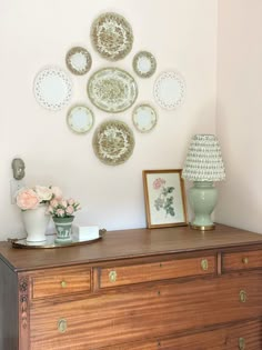 a wooden dresser topped with lots of plates