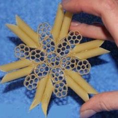 a person is holding some pasta in their hand and it looks like a snowflake