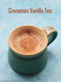 a cup of cinnamon vanilla tea sits on a blue surface with the words cinnamon vanilla tea above it