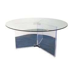 a glass table with a curved base