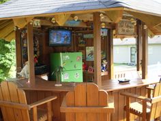 an outdoor bar with wooden chairs and tables