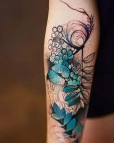 a woman's arm with flowers and leaves on it, in the background is an instagram