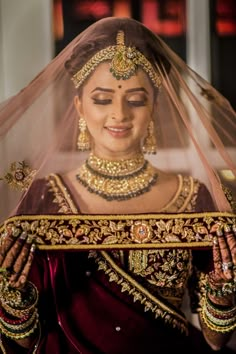 a woman wearing a bridal veil and jewelry