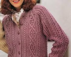 a woman wearing a purple sweater and hat