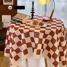 a table topped with a plate of food next to a lamp