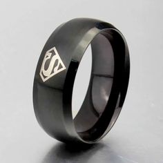 Black Superman 8mm Width Ring Size 14 Design Is Around The Ring 4 Times High Quality Titanium Metal Engagement, Wedding, Friendship, Love, Family, Gift Black Stainless Steel Promise Jewelry, Black Stainless Steel Promise Ring, Black Stainless Steel Couple Rings For Promise, Adjustable Black Couple Rings For Promise, Black Superman, Rope Bracelet Men, Wolf Pendant Necklace, Titanium Metal, Wolves Pendants