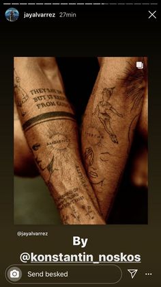 two people with tattoos on their arms are holding each other's hands and looking at the camera