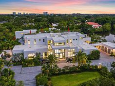 an aerial view of a large house surrounded by trees