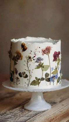 a white cake with flowers painted on it