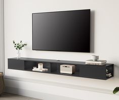 a flat screen tv mounted to the side of a wall