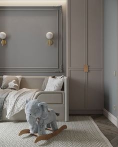 an elephant toy sitting on the floor next to a child's bed in a bedroom